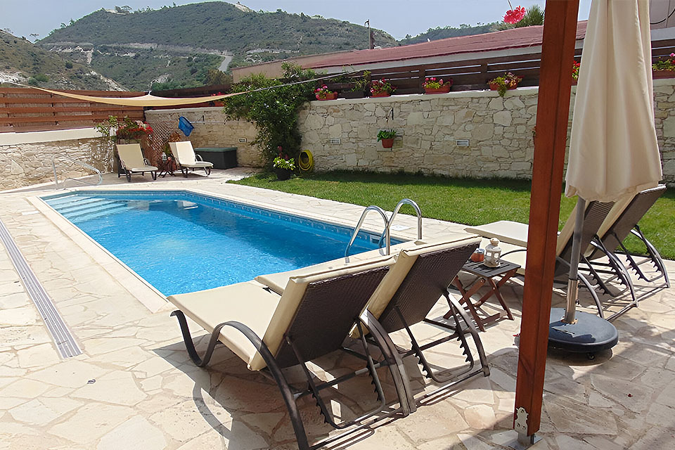 Sunbathing at the outdoors pool at Charalambos Houses Kalavasos